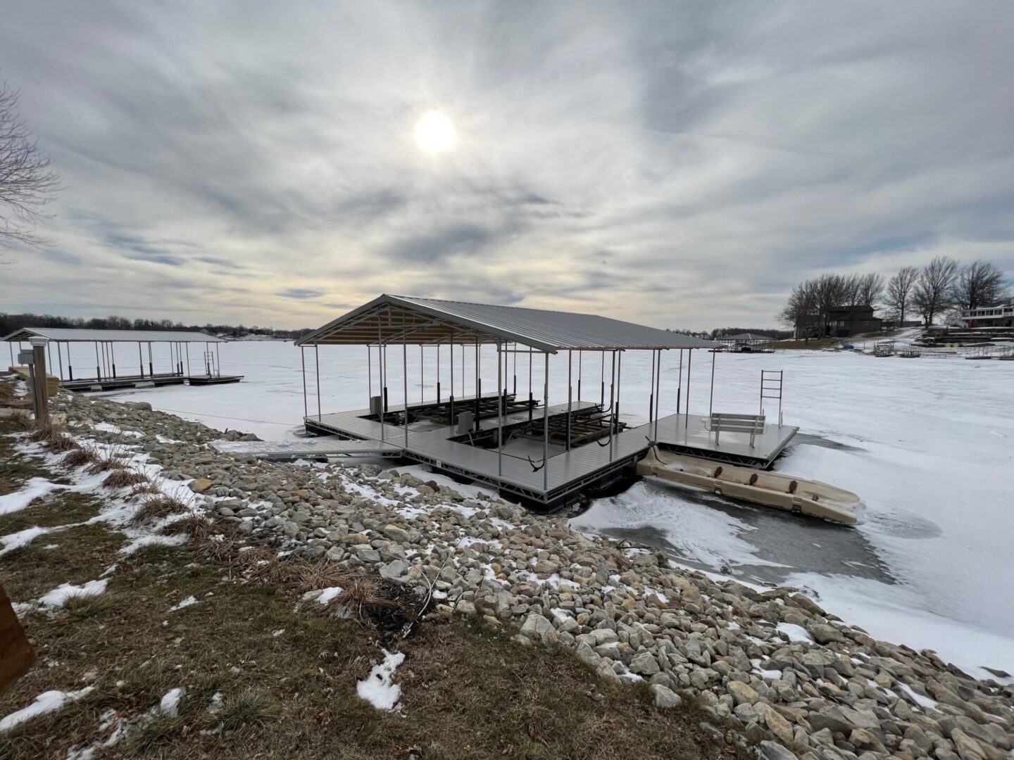 A dock with several boats on it in the snow.