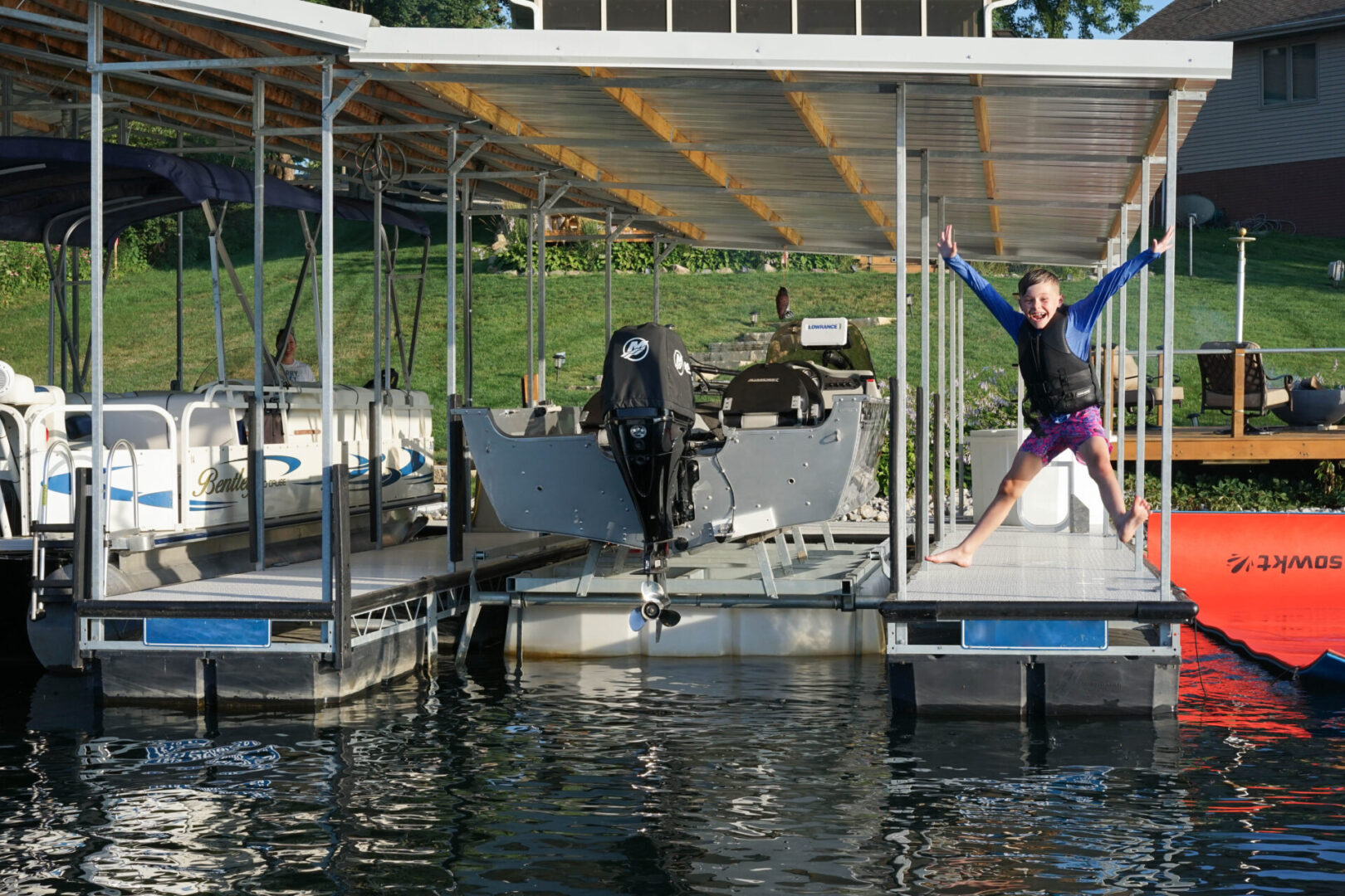 A woman is standing on the dock of her boat.