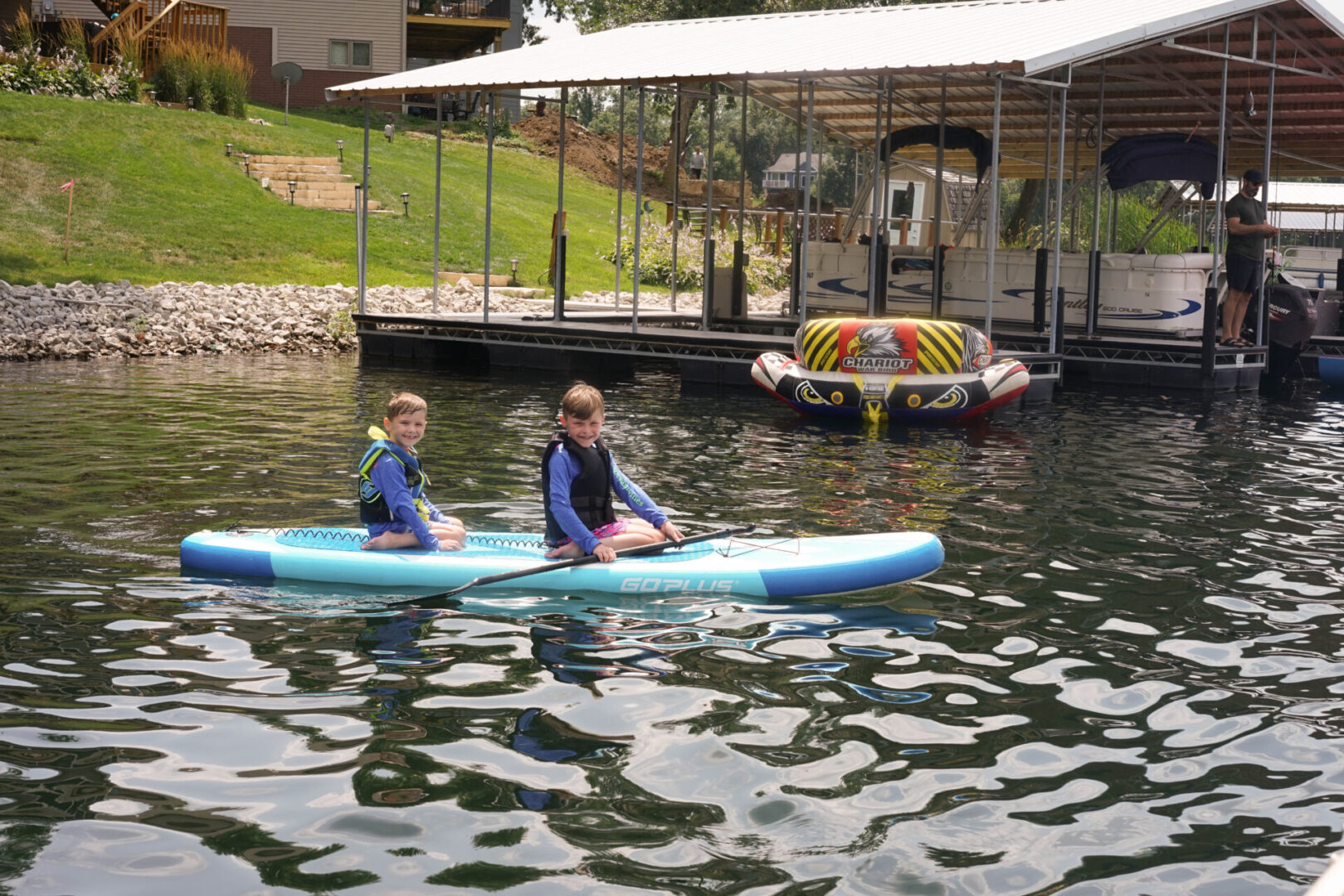 Two boys are sitting on a paddle boat.