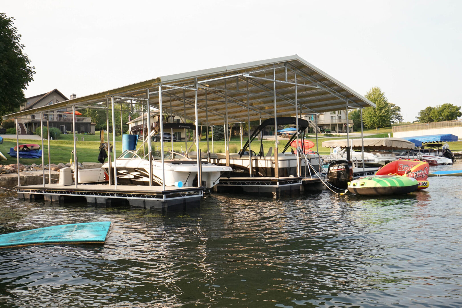 A boat dock with several boats in the water.