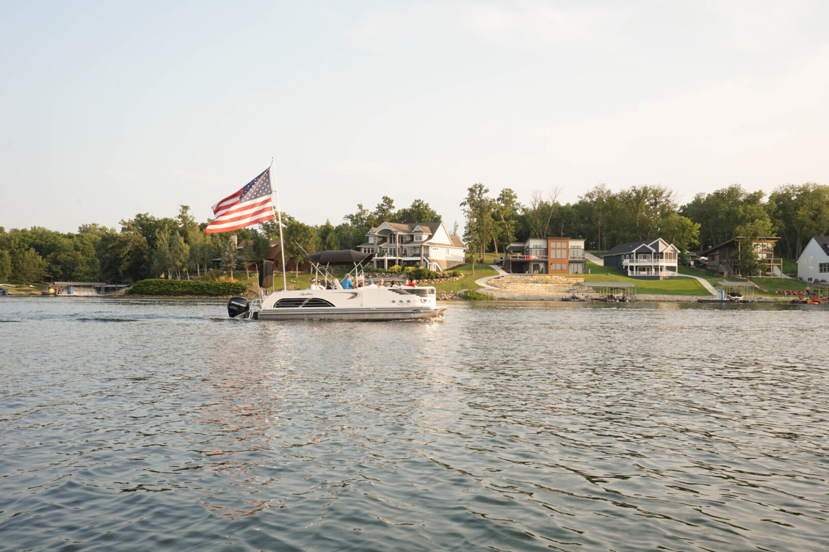 A boat is in the water near some houses.