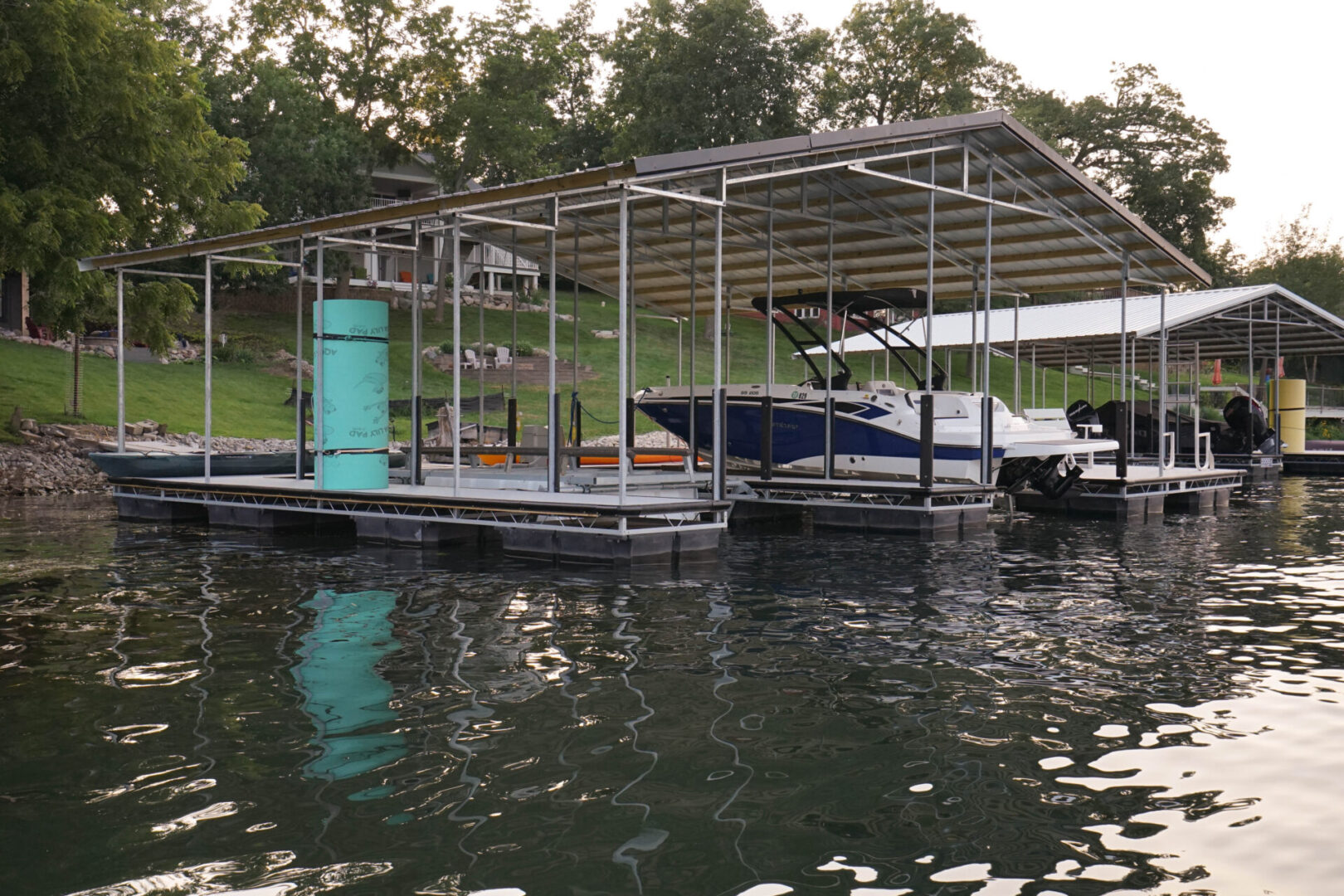 A boat dock with several boats parked on it.