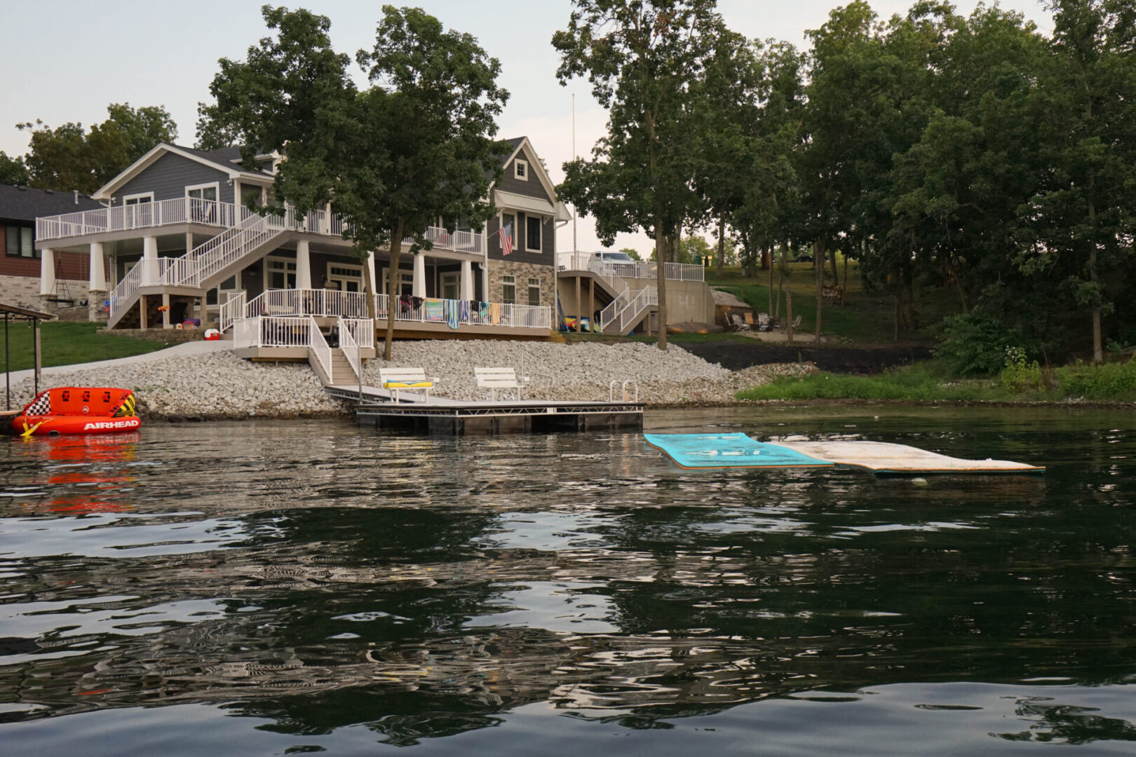 A boat is docked on the water near some houses.