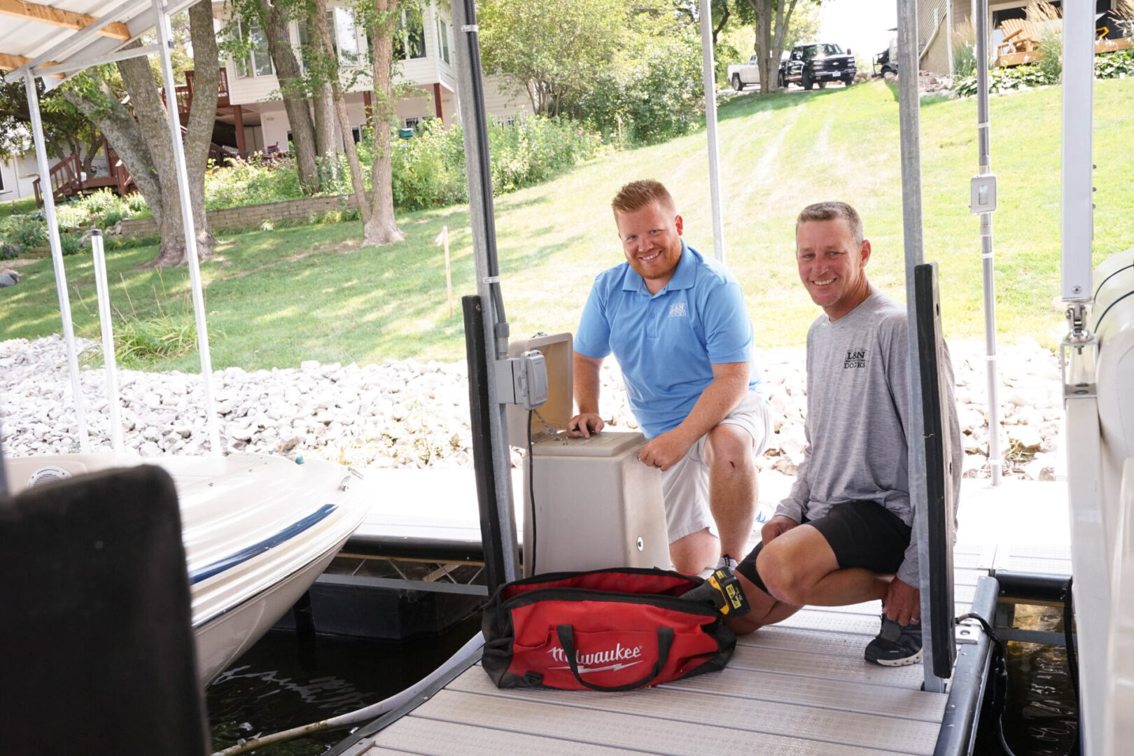 Two men are loading a boat onto the dock.