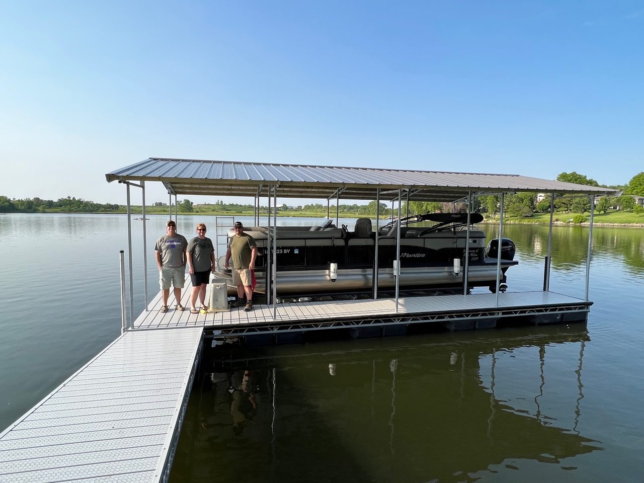 A group of people standing on the dock.