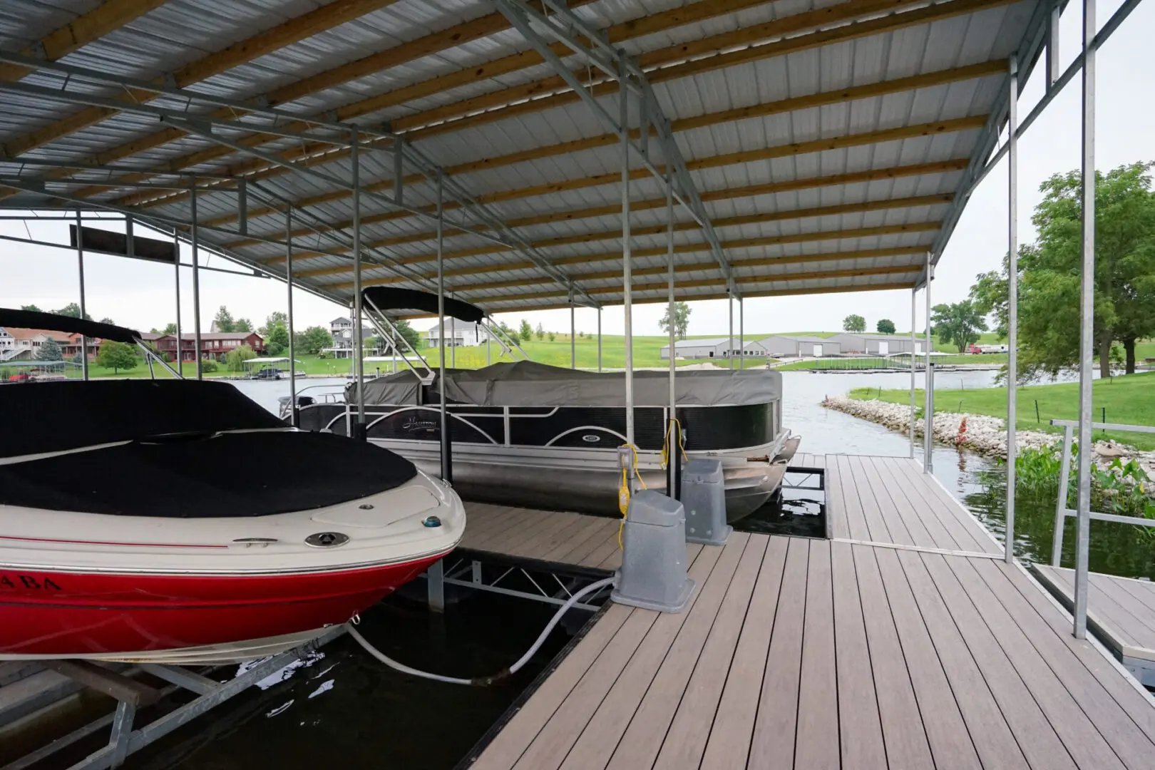 Boats docked under covered slip.