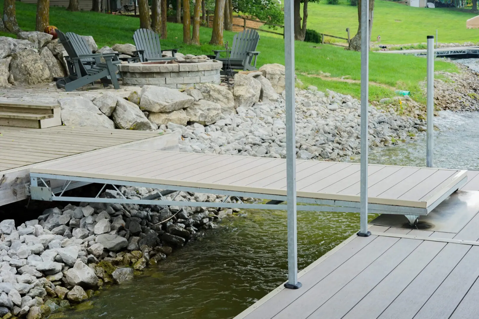 Lake dock with ramp and fire pit.