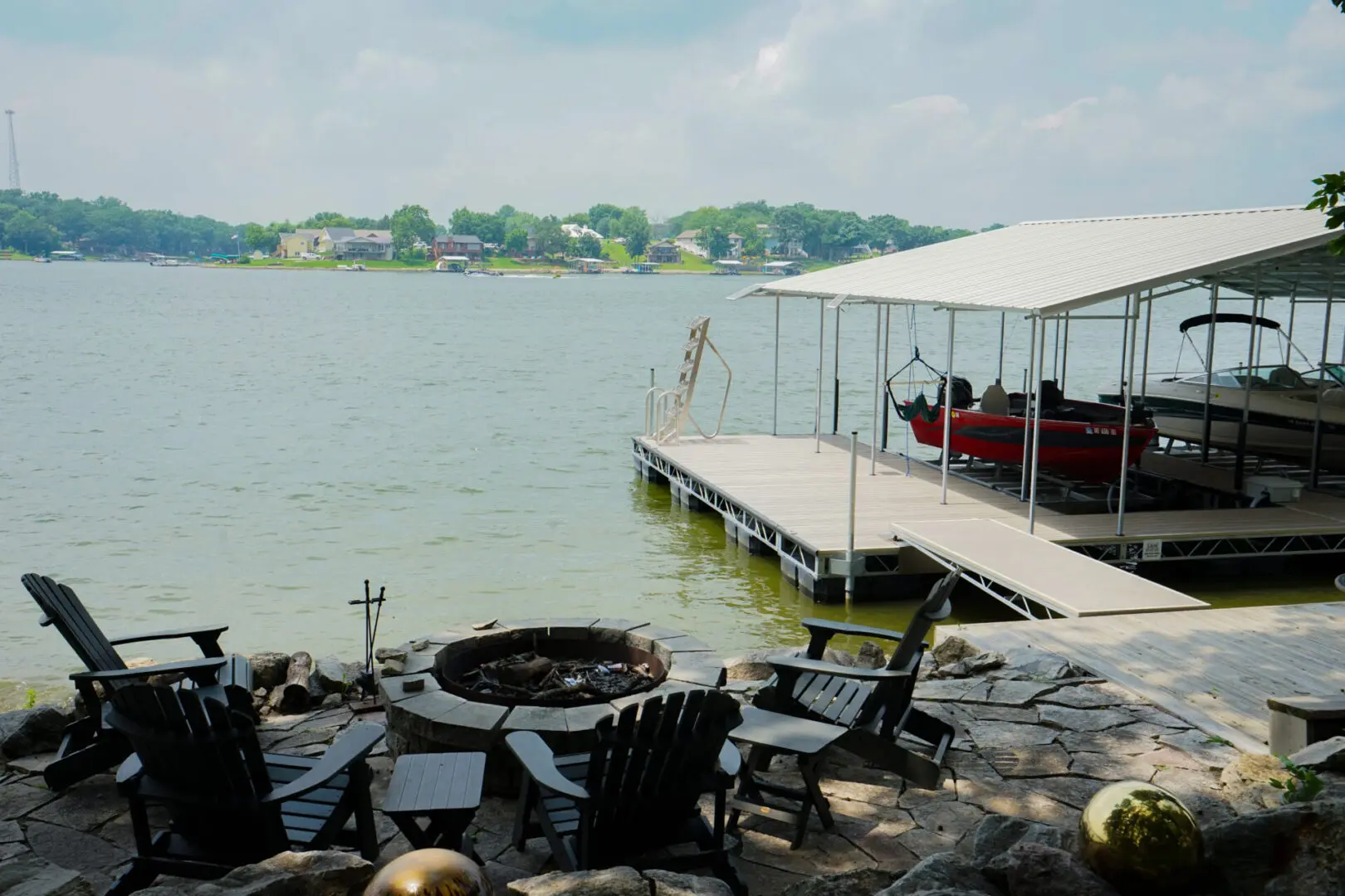 Lakeside fire pit, dock, and boats.