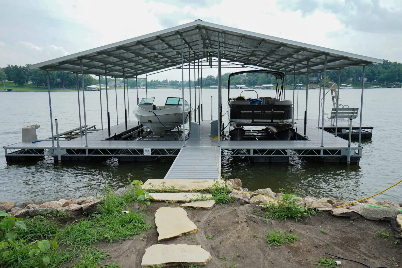 Boats sheltered under a lake dock.