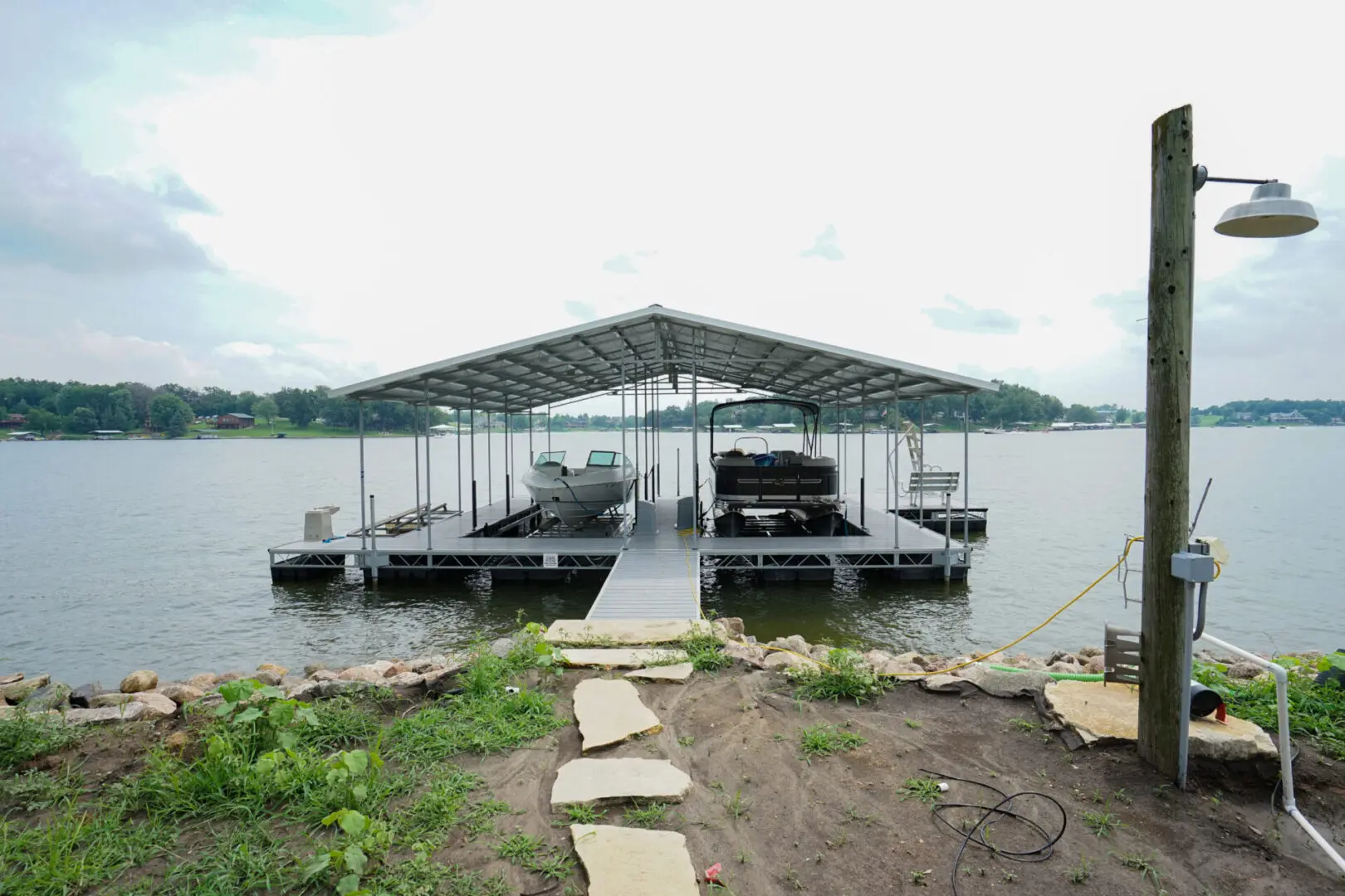 Lake dock with covered boat slips.