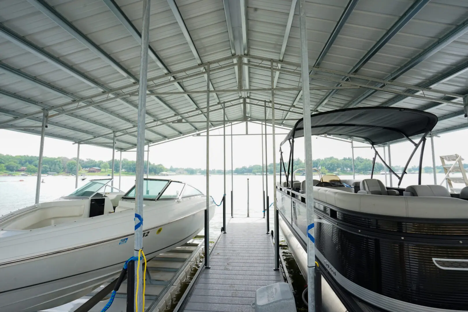 Two boats under a covered dock.