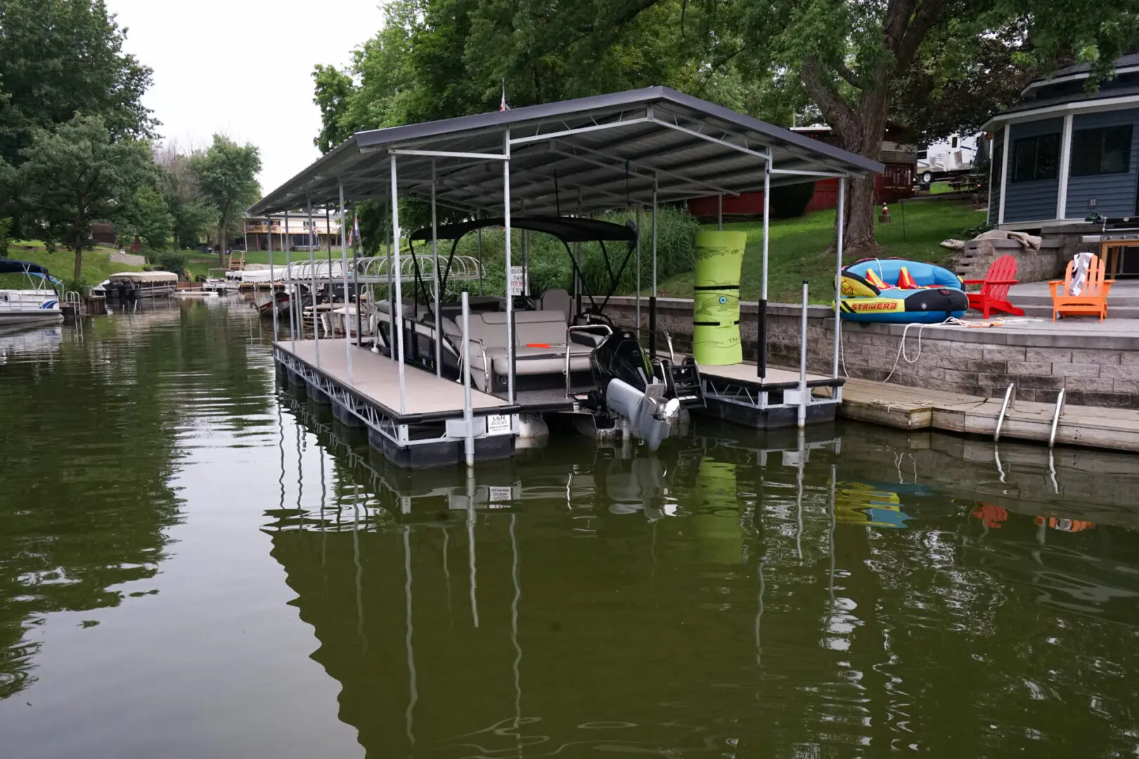 Boat docked under covered slip.