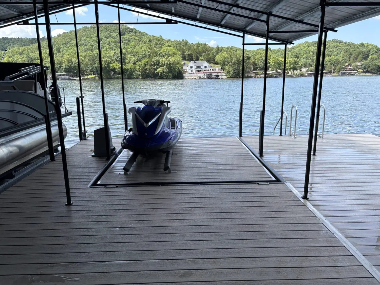Jet ski on lake dock under cover.