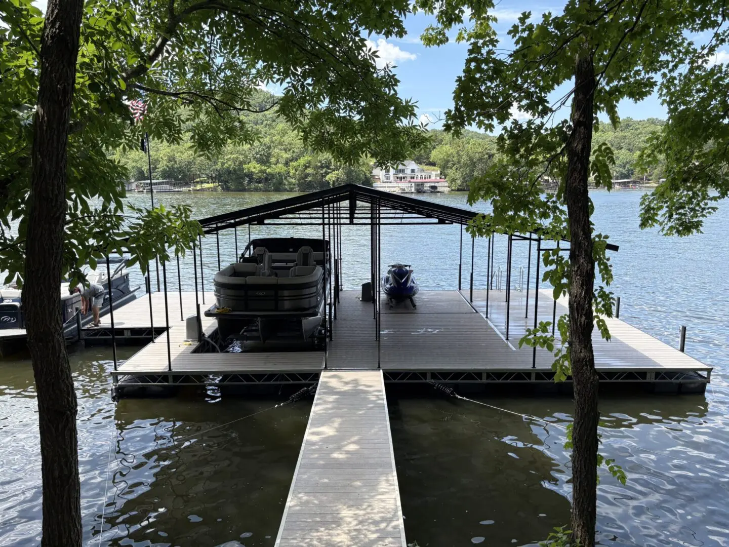 Lake dock with boat and jet ski.