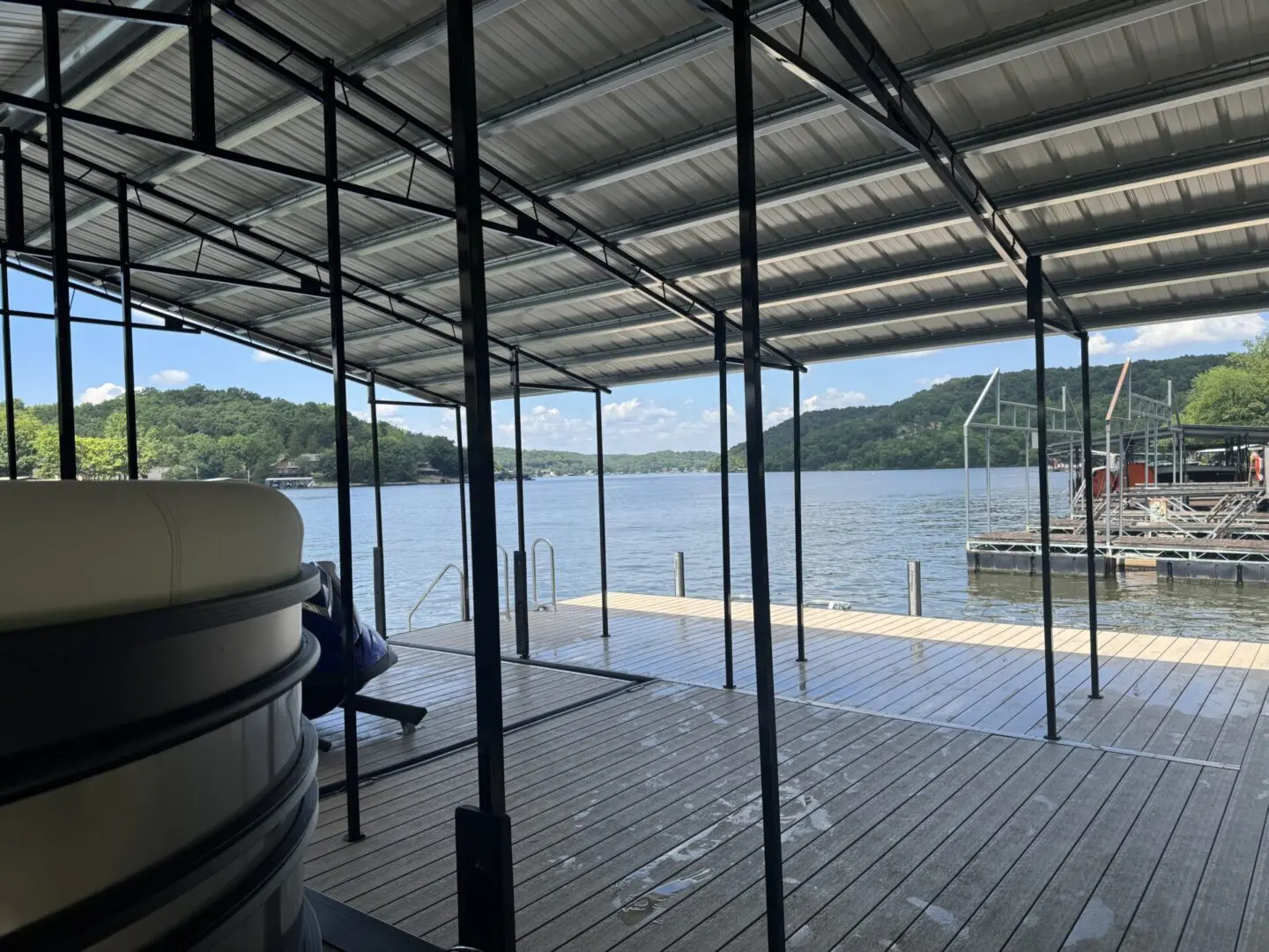 Covered dock overlooking calm lake.