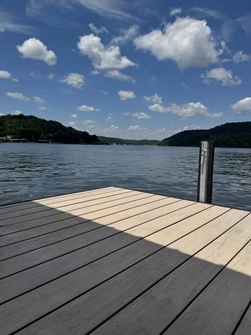 Here's an alt tag for the image: Sunny lake view from dock.